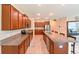 Open kitchen featuring an island with bar seating, granite countertops, and stainless steel appliances at 6416 Cobble Bliss St, Zephyrhills, FL 33541