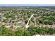 Aerial view of a residential area showcasing the property and surrounding neighborhood with lush trees at 6936 77Th N Ter, Pinellas Park, FL 33781