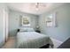 Bedroom with calming mint walls, tile flooring, and dual windows for ample natural light at 6936 77Th N Ter, Pinellas Park, FL 33781