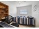 Bright bedroom with a ceiling fan, window, and a wooden bookshelf with items at 6936 77Th N Ter, Pinellas Park, FL 33781