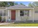 Charming front porch with a red door, two chairs and a small table, perfect for relaxing at 6936 77Th N Ter, Pinellas Park, FL 33781