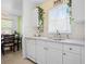 Bright kitchen featuring white cabinets, a stainless steel sink, and natural light at 6936 77Th N Ter, Pinellas Park, FL 33781
