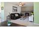 Cozy living room featuring a brick fireplace, ceiling fan, and comfortable seating arrangement at 6936 77Th N Ter, Pinellas Park, FL 33781