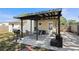 Outdoor patio space with a metal awning, a grill, a dining set, and lounge seating at 6936 77Th N Ter, Pinellas Park, FL 33781