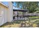 Outdoor patio area featuring a covered dining space, grill, and fenced-in yard for entertaining at 6936 77Th N Ter, Pinellas Park, FL 33781
