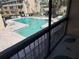Balcony view of a clean, well-maintained outdoor pool with surrounding lounge area and low-rise buildings at 7507 Presley Pl # D, Tampa, FL 33617