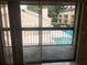 Balcony view of a fenced pool surrounded by low rise residential buildings and green spaces at 7507 Presley Pl # D, Tampa, FL 33617