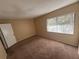 Bedroom features neutral walls, carpet, natural light from the window, and a door on the left at 7507 Presley Pl # D, Tampa, FL 33617