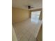 Spacious living room featuring tile floors, a modern ceiling fan, and sliding doors leading to a balcony at 7507 Presley Pl # D, Tampa, FL 33617