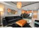 Well-lit living room featuring a black sofa, statement mirror, and decorative pendant lighting above the breakfast bar at 777 N Ashley Dr # 1516, Tampa, FL 33602