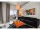 Inviting living area with a comfortable sofa, ottoman, and access to a private balcony overlooking the city at 777 N Ashley Dr # 1516, Tampa, FL 33602
