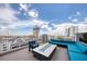Contemporary rooftop patio with a fire pit, ample seating, and a city view at 777 N Ashley Dr # 1516, Tampa, FL 33602