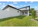 The backyard features a well-maintained lawn with a white brick home and fenced perimeter at 806 W Adalee St, Tampa, FL 33603