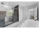 Beautiful bathroom with a glass shower, soaking tub, and views from the window at 806 W Adalee St, Tampa, FL 33603
