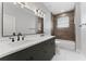 Modern bathroom with double vanity, sleek countertops, and tiled shower/tub combo creating a luxurious retreat at 806 W Adalee St, Tampa, FL 33603