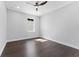 Neutral bedroom features dark wood floors, a ceiling fan, and a large window offering natural light at 806 W Adalee St, Tampa, FL 33603