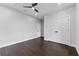 Bedroom with dark wood floors, a ceiling fan, and a double-door closet providing ample storage space at 806 W Adalee St, Tampa, FL 33603
