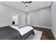 Spacious bedroom with a queen-sized bed, ceiling fan, and access to a walk-in closet and bathroom at 806 W Adalee St, Tampa, FL 33603