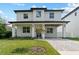 Stunning two-story home boasts a brick facade, covered porch, and manicured lawn at 806 W Adalee St, Tampa, FL 33603