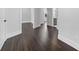 Hallway with wood-look floors, white trim, and open doorways into other rooms at 806 W Adalee St, Tampa, FL 33603