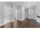 Hallway with wood-look floors, white trim, and open doorways to the rooms at 806 W Adalee St, Tampa, FL 33603