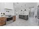 Modern kitchen featuring stainless steel appliances, kitchen island with a built-in microwave, and plenty of counter space at 806 W Adalee St, Tampa, FL 33603