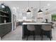 Gourmet kitchen with a marble island, stainless steel appliances, and designer lighting at 806 W Adalee St, Tampa, FL 33603