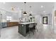 Spacious kitchen with stainless steel appliances, island with barstool seating, and modern lighting fixtures at 806 W Adalee St, Tampa, FL 33603