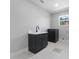 Laundry room with gray cabinetry, white countertops, and unique floor tile design at 806 W Adalee St, Tampa, FL 33603