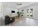 Bright and airy living room with tile floors, modern furniture, and access to the backyard at 806 W Adalee St, Tampa, FL 33603
