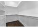 Spacious walk-in closet featuring custom shelves, drawers, and dark wood flooring for ample storage and organization at 806 W Adalee St, Tampa, FL 33603