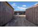 Backyard view showing the exterior of the house and its access through a closed fence at 8325 Elkwood Ln, Tampa, FL 33615