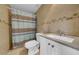 Bathroom features tiled walls, shower with curtain, and modern sink at 8325 Elkwood Ln, Tampa, FL 33615