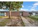 Charming home featuring a secure gated front entrance and walkway to the front door at 8325 Elkwood Ln, Tampa, FL 33615