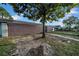 Side view of home featuring a spacious yard and gated entrance enhancing curb appeal at 8325 Elkwood Ln, Tampa, FL 33615