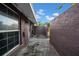 Side yard featuring privacy wall, exterior lighting, and secure access at 8325 Elkwood Ln, Tampa, FL 33615