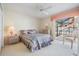 Bedroom with a queen bed and sliding glass doors leading to the backyard at 9008 Quail Creek Dr, Tampa, FL 33647