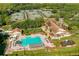 Aerial view of community amenities, including a pool, tennis courts, and clubhouse at 9008 Quail Creek Dr, Tampa, FL 33647