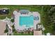 Overhead view of community pool and spa area with lounge chairs and a covered seating area at 9008 Quail Creek Dr, Tampa, FL 33647
