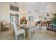 Bright dining area showing a chandelier, glass table, and connection to the living room at 9008 Quail Creek Dr, Tampa, FL 33647