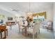 Open dining room with glass-top table, chandelier, and views into the living area at 9008 Quail Creek Dr, Tampa, FL 33647