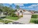Charming single-Gathering home featuring a well-manicured lawn, two-car garage, and mature landscaping at 9008 Quail Creek Dr, Tampa, FL 33647