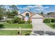 Charming single-Gathering home with brick accents, mature landscaping, and two-car garage at 9008 Quail Creek Dr, Tampa, FL 33647