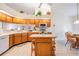 Spacious kitchen with wooden cabinets, island, and bright natural light at 9008 Quail Creek Dr, Tampa, FL 33647