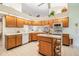 Kitchen with wooden cabinets, bright countertops and modern appliances at 9008 Quail Creek Dr, Tampa, FL 33647