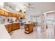 Bright eat-in kitchen featuring wooden cabinetry and a mobile island at 9008 Quail Creek Dr, Tampa, FL 33647