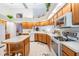 Kitchen with wood cabinetry, island, and modern appliances at 9008 Quail Creek Dr, Tampa, FL 33647