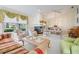 Cozy living room boasts a fireplace, ample seating, and a ceiling fan at 9008 Quail Creek Dr, Tampa, FL 33647