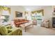 Bright living room featuring large windows and comfortable seating arrangements at 9008 Quail Creek Dr, Tampa, FL 33647