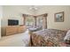 Bright main bedroom with a large window looking out to the fenced-in backyard at 9008 Quail Creek Dr, Tampa, FL 33647